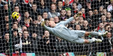 A crowd of people watching a football ball