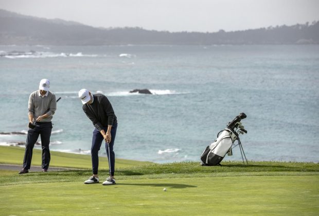 Two persons playing golf