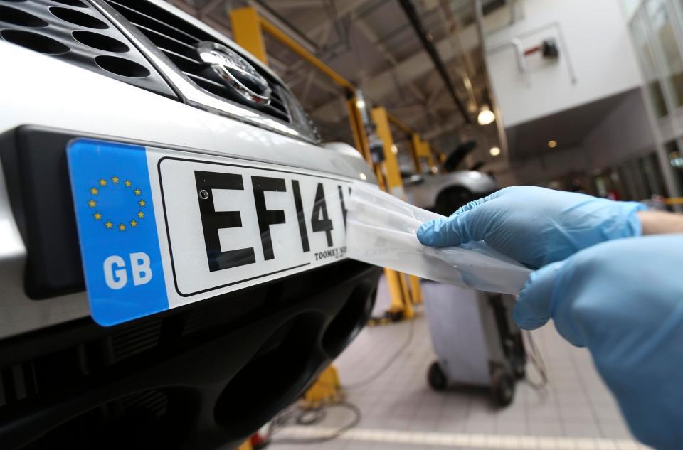 A person remove caver on car number plate